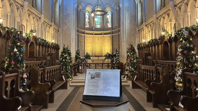 Community decorated trees sparkling in the chapel at Killerton, Devon